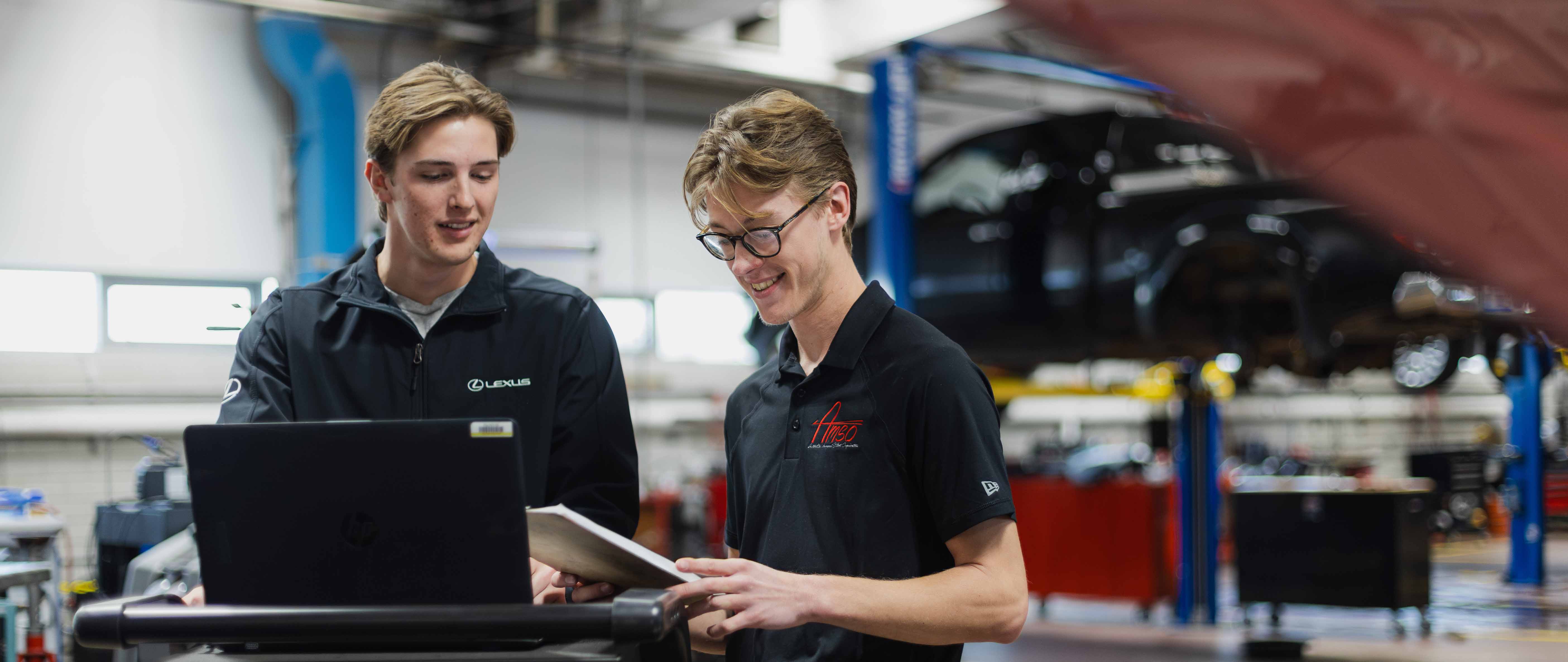 automotive management students in a vehicle repair shop