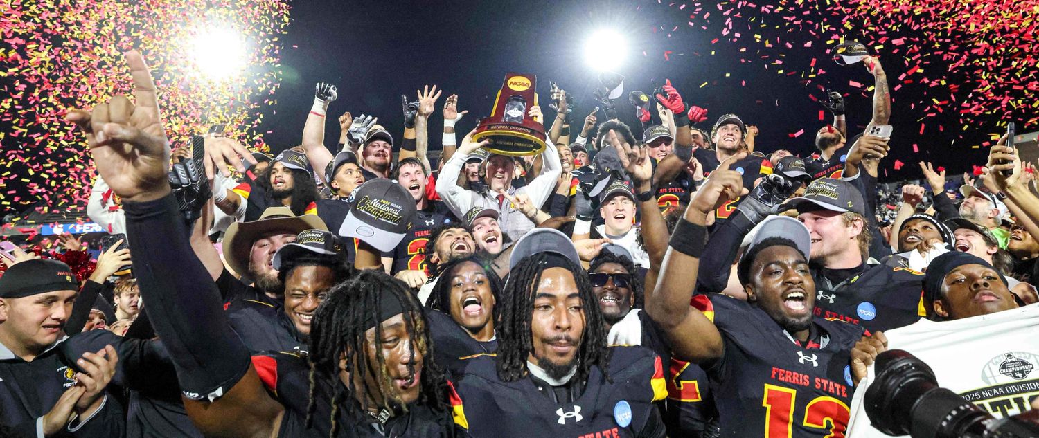 Football team hoisting the 2025 championship trophy