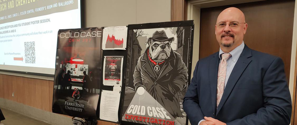 Ferris State Professor, Steven Amey, standing in front of a poster board.