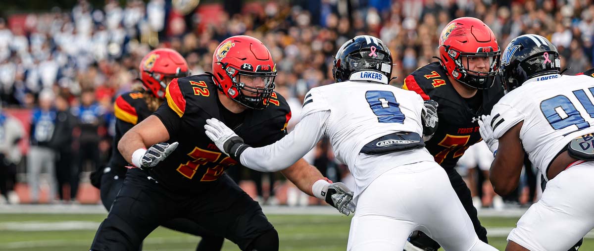 Action shot of Tim and Bob Anderson in pass protection