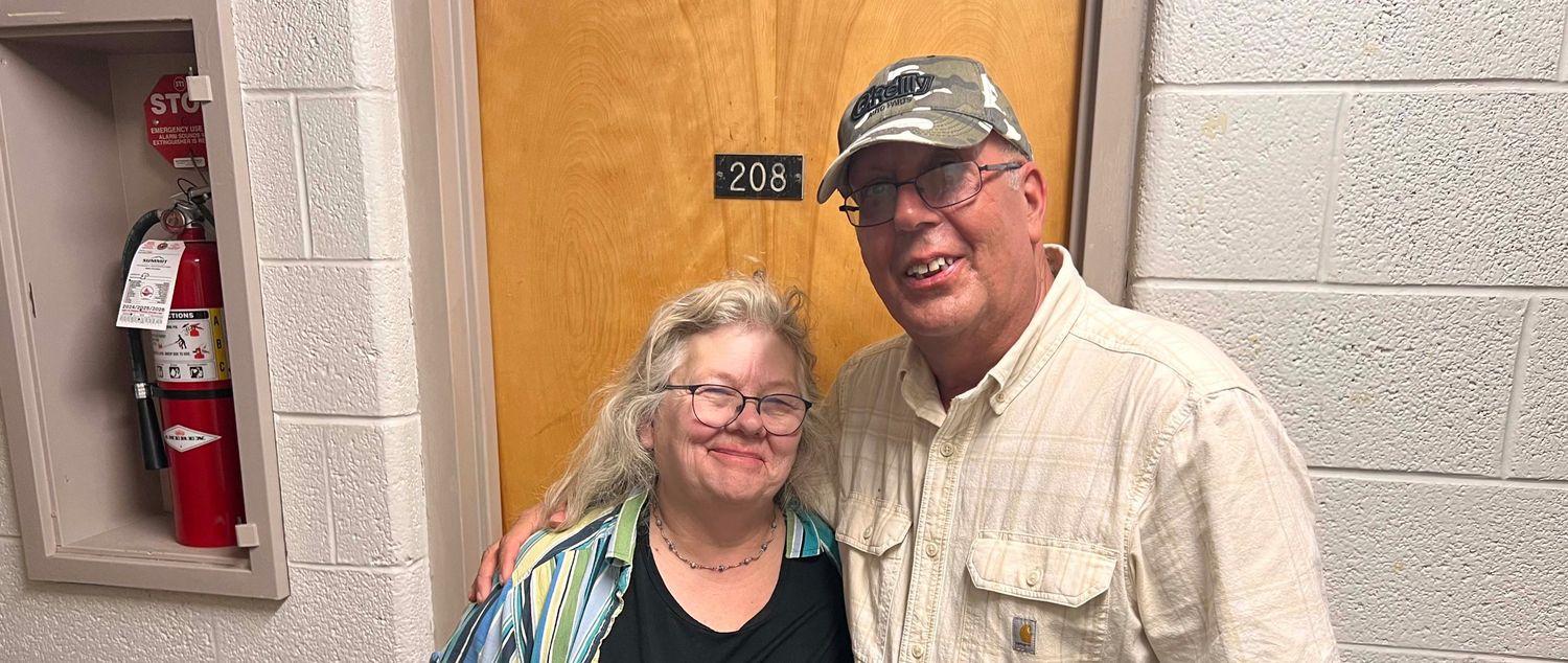 The Beitner's standing in front of Todd's old dorm in Hallisy Hall