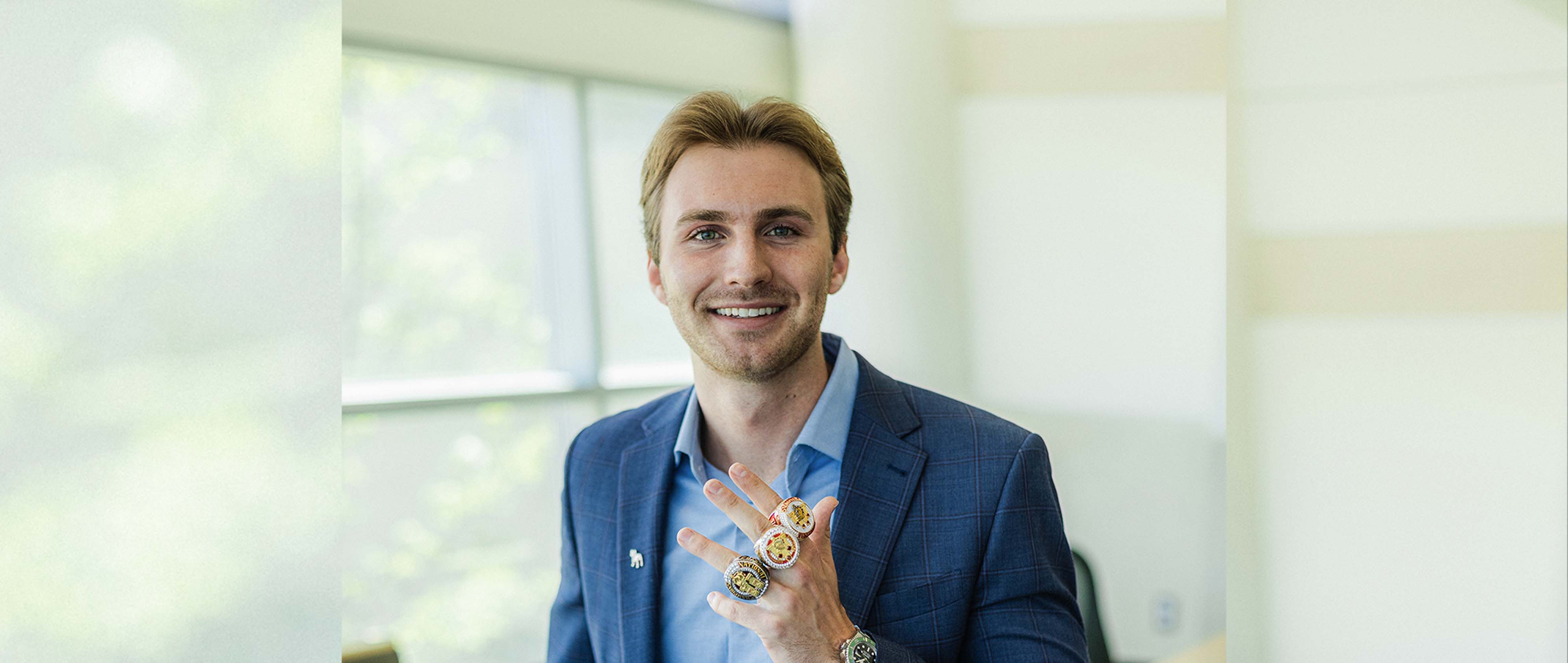 Levi Tuinstra with his three football national championship rings.