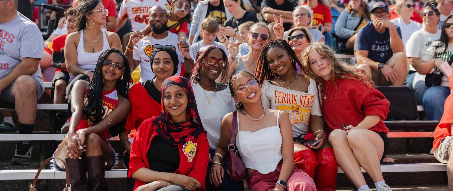 Students, alumni, and families during a homecoming football game