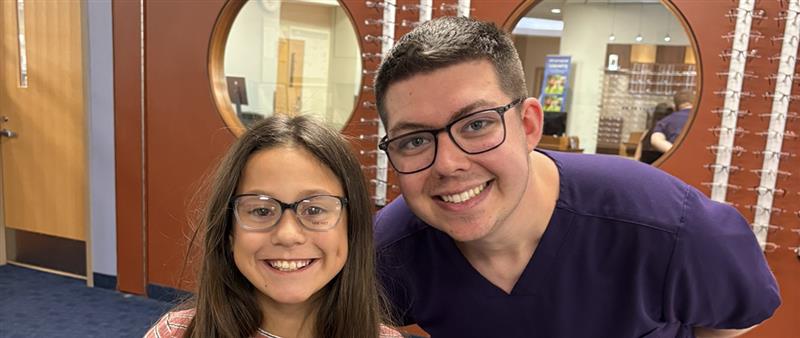 optometry student with young patient