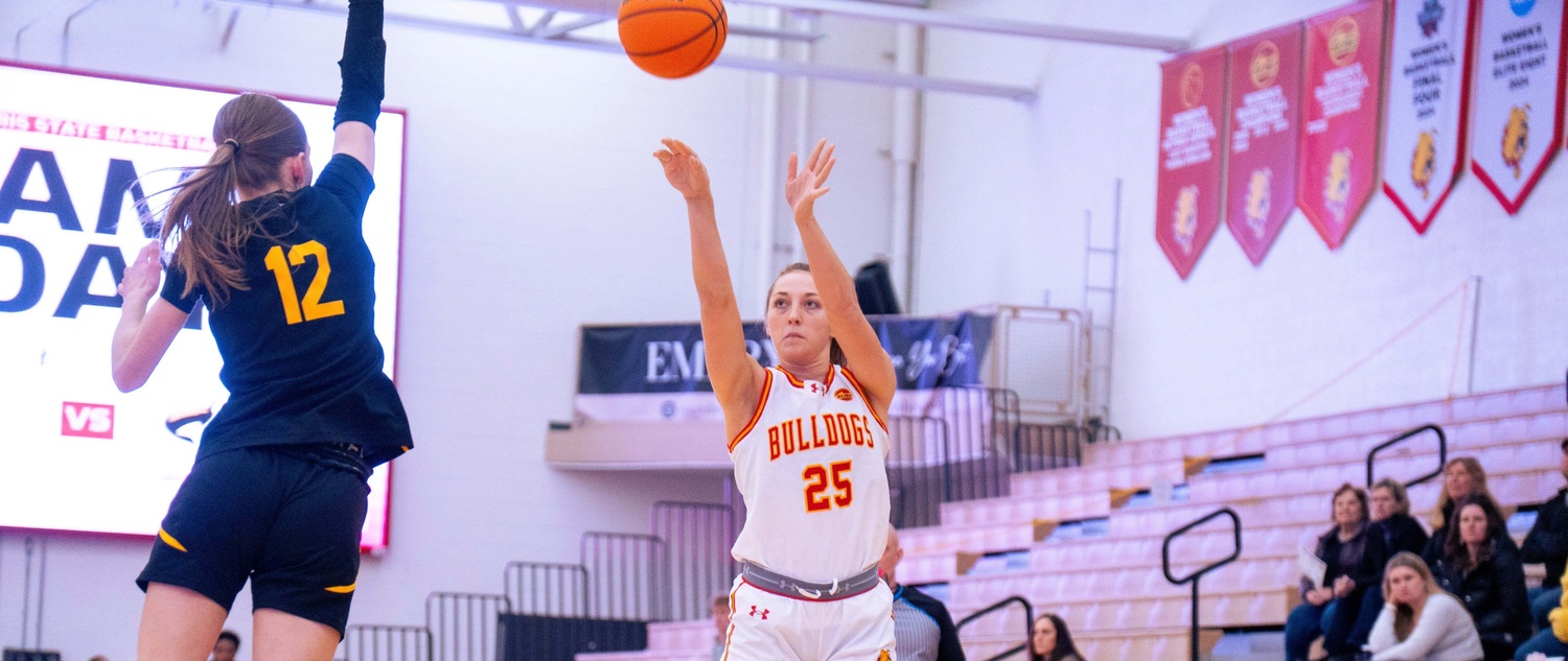 Mia Riley attempting a jumper over a Michigan Tech defender