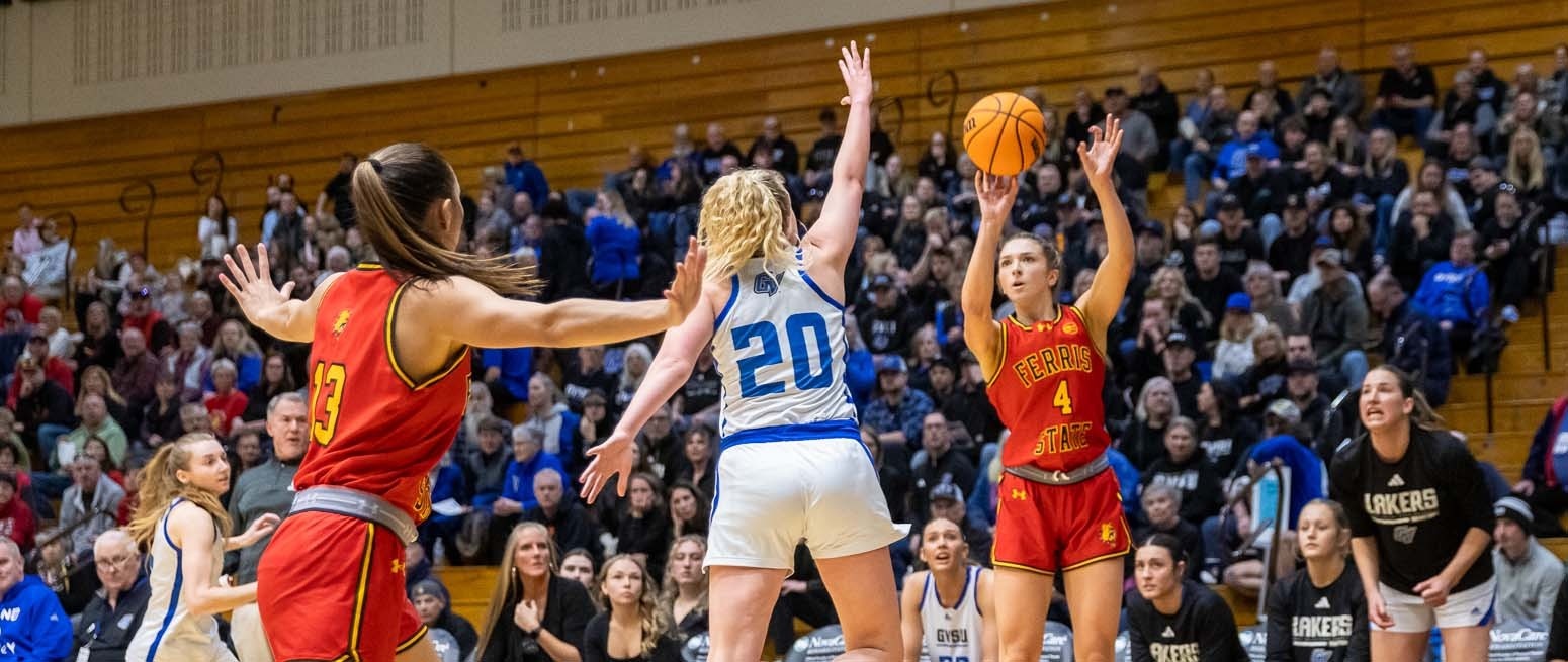 Elle Irwin (#4) attempting a jump shot over a Grand Valley State defender