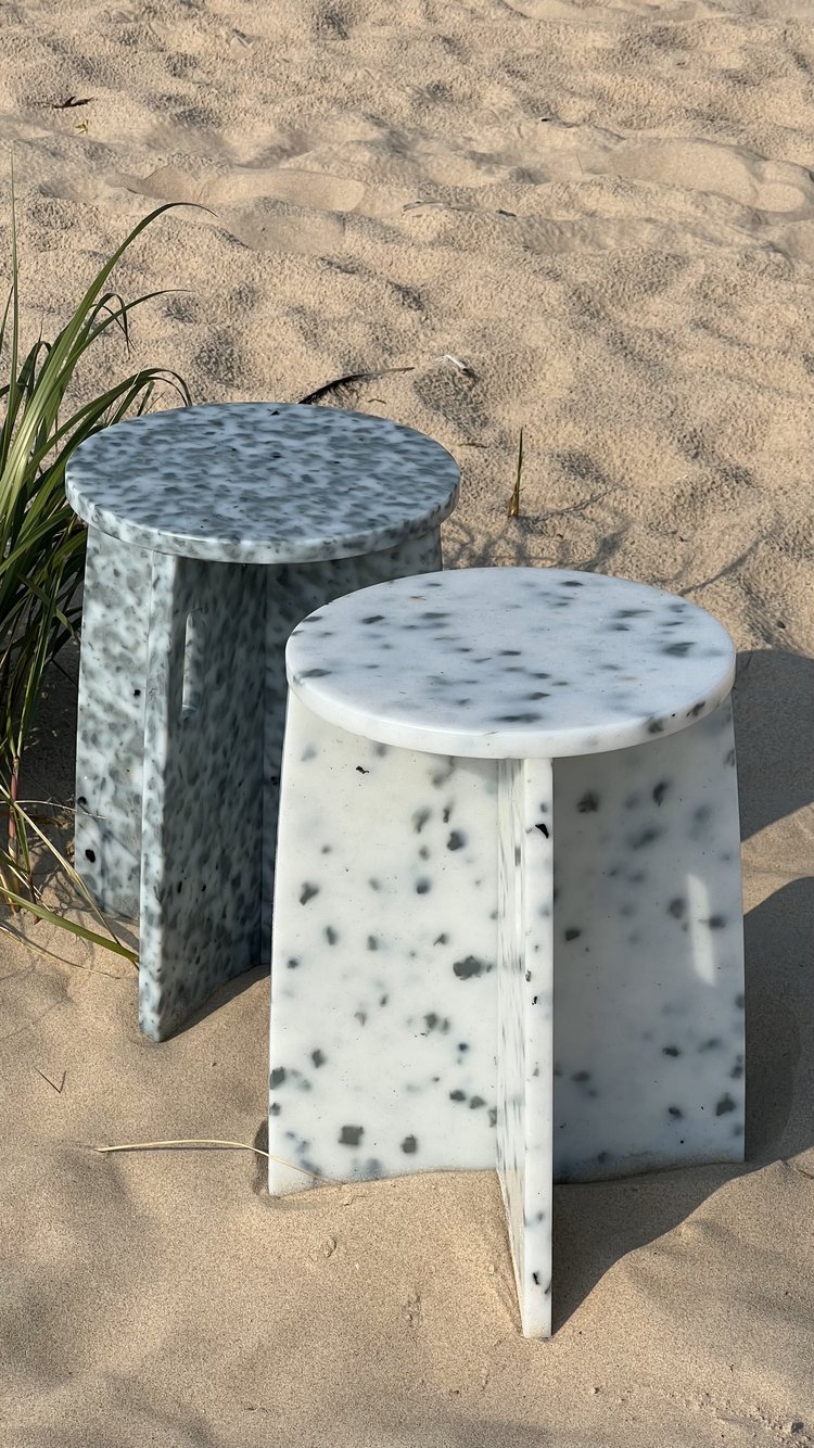 two plastic tables, white and grayish color with speckles