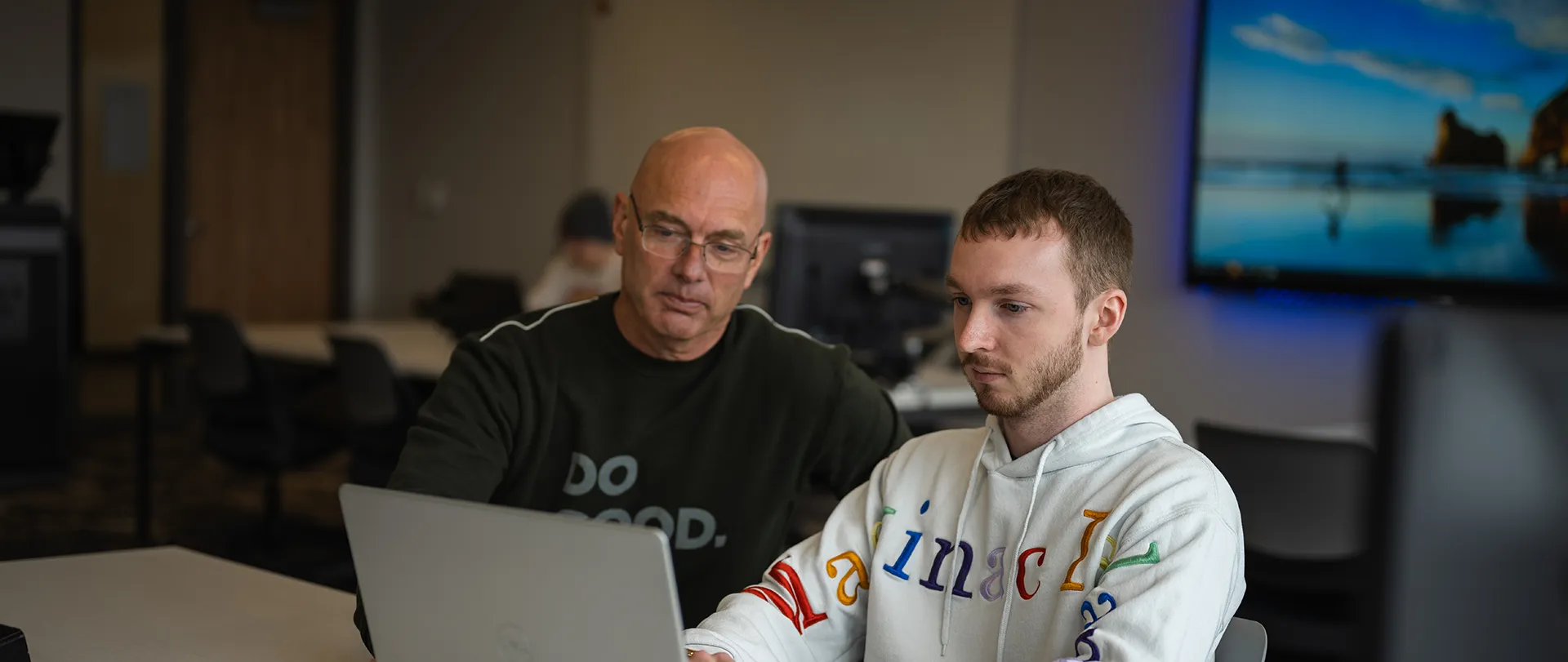 Student and instructor working with computer